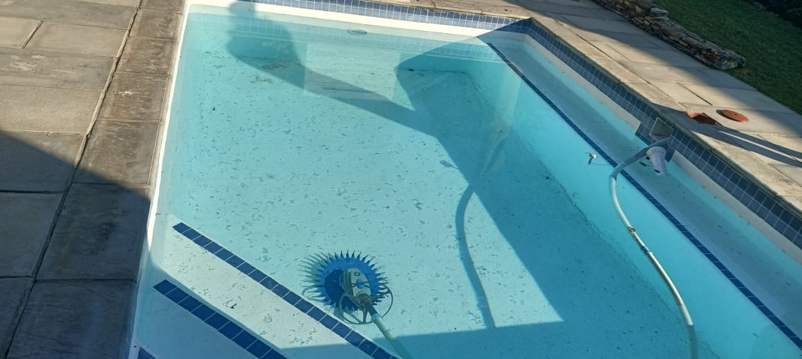 Swimming pool being cleaned and serviced during routine maintenance